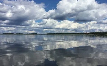 Clouds Reflecting Over The Lakes Surface